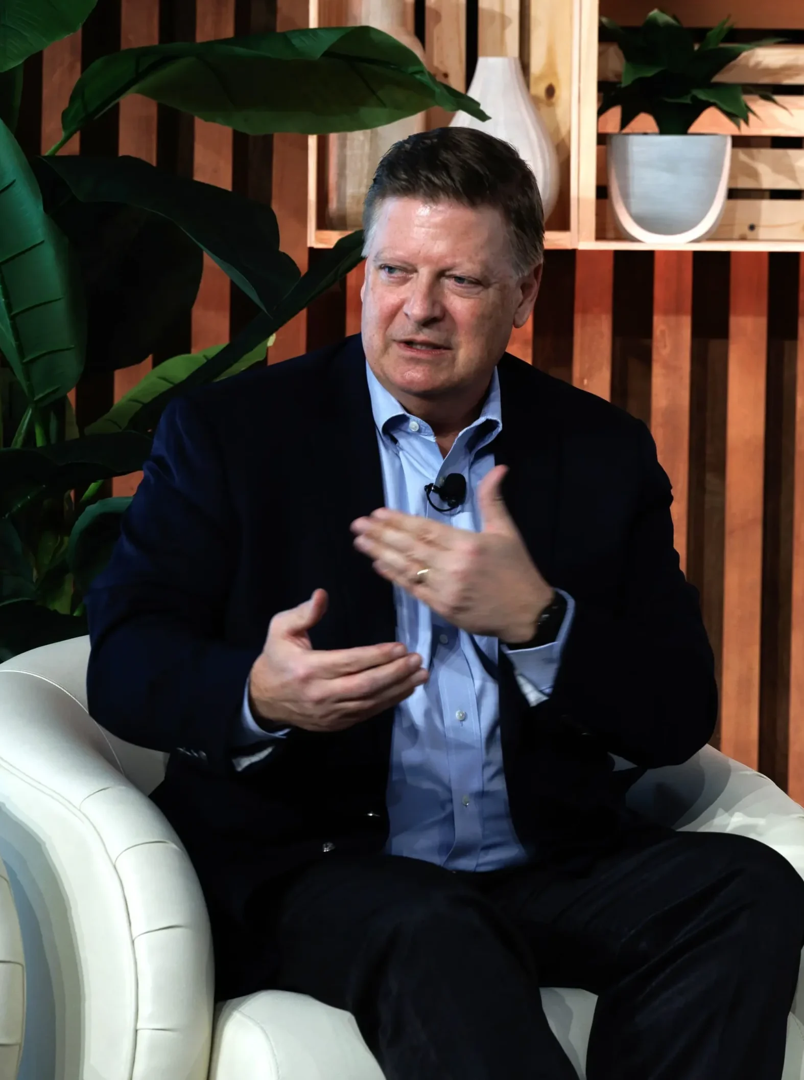 Jim Potter speaking at the POC Now Summit 2025 on stage with microphone