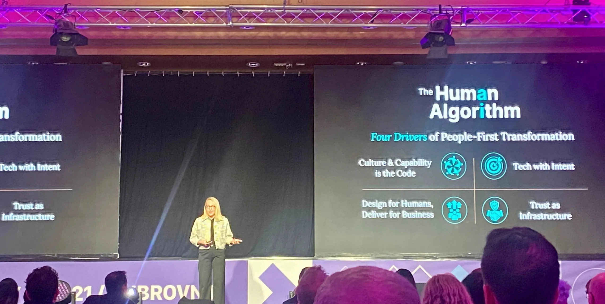 Alyssa presenting at Next Pharma Summit on stage with screens behind her
